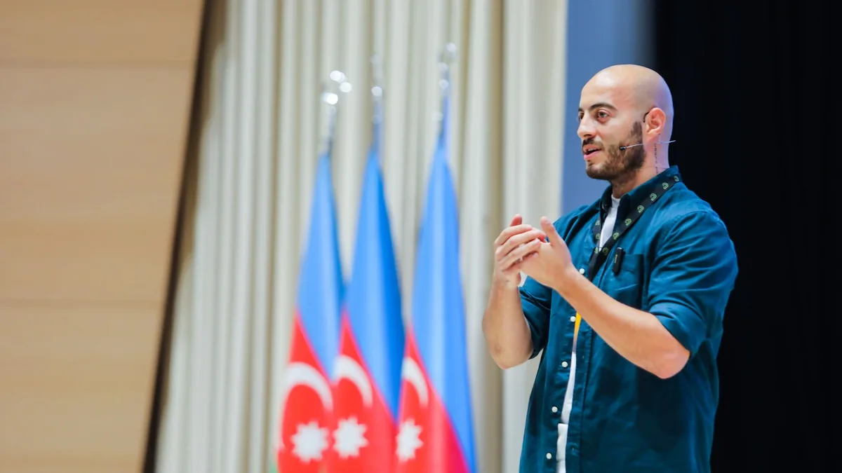 Man speaking at an event in baku azerbaijan with azerbai 18751164